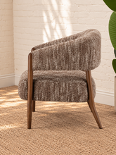 Load image into Gallery viewer, Abby mocha textured bouclé accent chair with curved wraparound backrest, cushioned seat and exposed brown solid wood legs.
