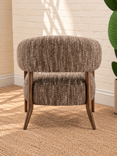 Load image into Gallery viewer, Abby mocha textured bouclé accent chair with curved wraparound backrest, cushioned seat and exposed brown solid wood legs.

