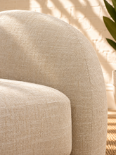 Load image into Gallery viewer, Adriana ivory chenille accent chair with rounded wraparound back, curved upholstered arms, plush seat cushion, and sculptural silhouette.
