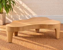Load image into Gallery viewer, Alani solid oak coffee table in a natural oak finish with an abstract freeform tabletop, rounded edges, and tapered wood legs.
