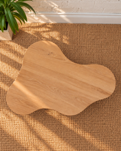 Load image into Gallery viewer, Alani solid oak coffee table in a natural oak finish with an abstract freeform tabletop, rounded edges, and tapered wood legs.
