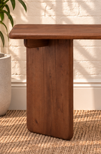 Load image into Gallery viewer, Alijah sculptural desk in natural brown mindi wood with rounded rectangular top, asymmetrical slab legs, and curved under-top supports.
