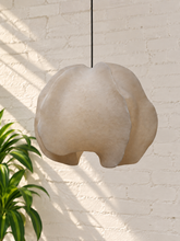 Load image into Gallery viewer, Alora hanging lamp in oyster resin with overlapping organic panels, softly undulating edges, textured surface, and dark cord suspension.
