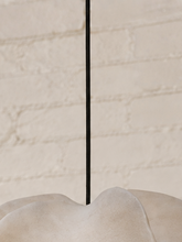 Load image into Gallery viewer, Alora hanging lamp in oyster resin with overlapping organic panels, softly undulating edges, textured surface, and dark cord suspension.
