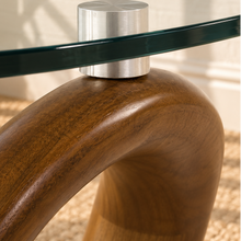 Load image into Gallery viewer, Amalia round glass coffee table with sculptural sinuous walnut wave base and metal glass supports.
