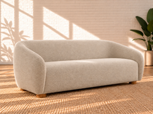 Load image into Gallery viewer, Image 3 of 6: Amara 85-inch upholstered sofa in Greige chenille with curved back, rounded arms, ball accent pillows, and wood bun feet
