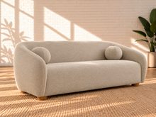 Load image into Gallery viewer, Image 4 of 6: Amara 85-inch upholstered sofa in Greige chenille with curved back, rounded arms, ball accent pillows, and wood bun feet
