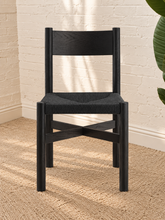 Load image into Gallery viewer, Amelie charcoal solid oak dining chair with woven paper-rope seat, curved wood backrest, rounded legs, and X-shaped stretcher
