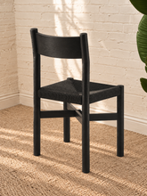 Load image into Gallery viewer, Amelie charcoal solid oak dining chair with woven paper-rope seat, curved wood backrest, rounded legs, and X-shaped stretcher
