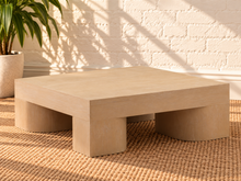 Load image into Gallery viewer, Arnold square coffee table in natural mindi wood veneer with a thick tabletop and sculptural curved supports.
