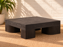 Load image into Gallery viewer, Arnold square coffee table in natural dark brown mindi wood veneer with a thick tabletop and sculptural curved supports.
