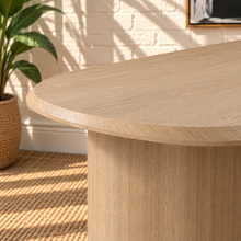 Load image into Gallery viewer, Arya natural ash veneer oval dining table with rounded edges and sculptural triple pedestal legs.
