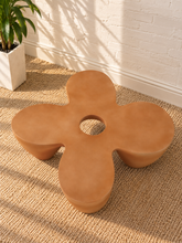 Load image into Gallery viewer, Aster sculptural coffee table in Amber fiber-reinforced concrete with four rounded pedestal forms and a distinctive central tabletop opening.

