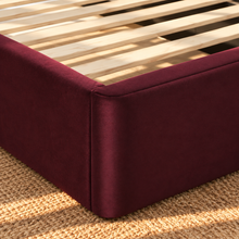 Load image into Gallery viewer, Astrid King-size bed in Burgundy performance velvet with sculptural arched headboard and streamlined plinth base.

