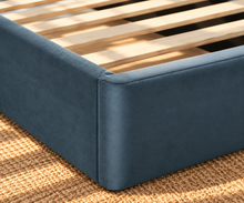 Load image into Gallery viewer, Astrid King-size bed in Slate Blue performance velvet with sculptural arched headboard and streamlined plinth base.
