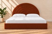 Load image into Gallery viewer, Astrid King-size bed in Terracotta performance velvet with sculptural arched headboard and streamlined plinth base.
