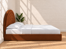 Load image into Gallery viewer, Astrid King-size bed in Terracotta performance velvet with sculptural arched headboard and streamlined plinth base.

