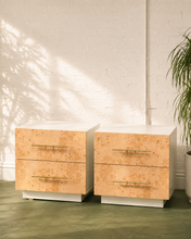Load image into Gallery viewer, Pair of vintage burl wood nightstands with two drawers, white lacquer cases, and brass handles.
