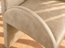 Load image into Gallery viewer, Bailey upholstered dining chair in Champagne Sand velvet with curved arms and sculptural contemporary frame
