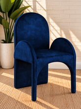 Load image into Gallery viewer, Bailey upholstered dining chair in Royal Navy velvet with curved arms and sculptural contemporary frame
