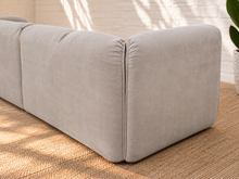 Load image into Gallery viewer, Blaire four piece modular sectional sofa upholstered in cloud gray fabric with four seat cushions, loose back cushions, and softly draped side cushions.
