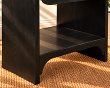 Load image into Gallery viewer, Byron charcoal wood nightstand with curved frame, drawer, matte black handle, and open lower shelf.
