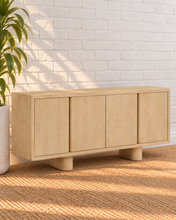 Load image into Gallery viewer, Cailah natural light reclaimed pine wood credenza with four cabinet doors, subtle wood grain, interior shelving, and rounded pedestal legs.

