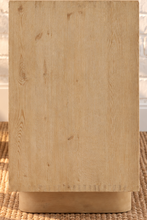 Load image into Gallery viewer, Cailah natural light reclaimed pine wood credenza with four cabinet doors, subtle wood grain, interior shelving, and rounded pedestal legs.

