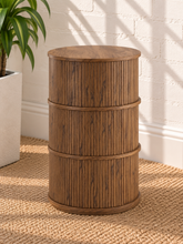 Load image into Gallery viewer, Cairo warm wood cylindrical storage side table with vertical fluted detailing and three sliding tambour doors
