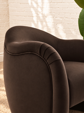 Load image into Gallery viewer, Capri lounge chair in Espresso performance velvet with curved barrel back, rounded arms, French piping, and pleated detailing
