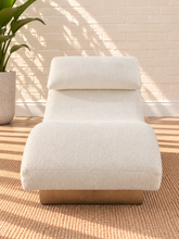 Load image into Gallery viewer, Carlyn sculptural chaise lounge in cloud ivory polyester with curved upholstery and natural wood base.
