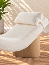 Load image into Gallery viewer, Carlyn sculptural chaise lounge in cloud ivory polyester with curved upholstery and natural wood base.
