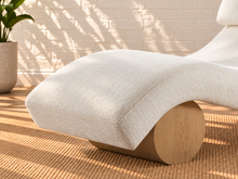 Load image into Gallery viewer, Carlyn sculptural chaise lounge in cloud ivory polyester with curved upholstery and natural wood base.
