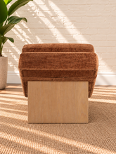 Load image into Gallery viewer, Carlyn sculptural chaise lounge in toasted chestnut polyester with curved upholstery and natural wood base.
