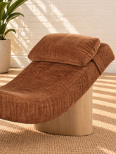 Load image into Gallery viewer, Carlyn sculptural chaise lounge in toasted chestnut polyester with curved upholstery and natural wood base.
