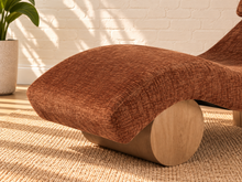 Load image into Gallery viewer, Carlyn sculptural chaise lounge in toasted chestnut polyester with curved upholstery and natural wood base.
