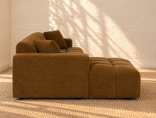 Load image into Gallery viewer, Cayden caramel upholstered L-shaped sectional sofa with left-facing chaise, tufted seat and back, square arms, and two matching throw pillows.
