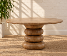 Load image into Gallery viewer, Charlie round natural mango wood dining table with broad tabletop and sculptural rounded pedestal base.
