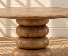Load image into Gallery viewer, Charlie round natural mango wood dining table with broad tabletop and sculptural rounded pedestal base.
