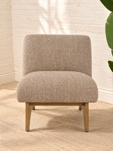 Load image into Gallery viewer, Kyro oat beige upholstered slipper chair with rounded tight back, cushioned seat and sculptural oak veneer wood legs.
