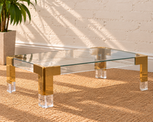 Load image into Gallery viewer, Cindy rectangular coffee table with clear glass top, polished gold stainless steel frame, and transparent acrylic legs.
