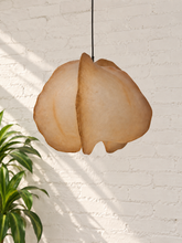 Load image into Gallery viewer, Claire hanging lamp in warm camel resin with an organic sculptural shade, overlapping curved forms, textured surface, and dark cord suspension.
