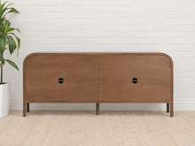 Load image into Gallery viewer, Collin four-door dark walnut media cabinet with rounded upper corners, integrated wood pulls and slim solid wood legs.
