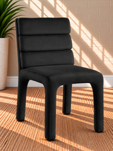 Load image into Gallery viewer, Conrad upholstered dining chair in Midnight Black velvet with deep channel-tufted back and sculptural upholstered frame
