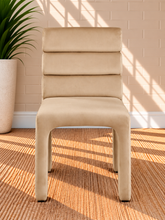 Load image into Gallery viewer, Conrad upholstered dining chair in Vanilla Sand velvet with deep channel-tufted back and sculptural upholstered frame
