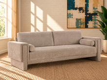 Load image into Gallery viewer, Corinne sofa in Greige chenille fabric with two back cushions, matching bolster pillows, structured arms, and contemporary design.

