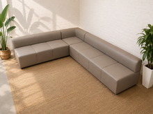 Load image into Gallery viewer, Vintage Steelcase L-shaped modular sectional sofa in warm taupe upholstery with geometric seats and low continuous padded backrests.
