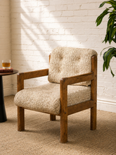 Load image into Gallery viewer, Vintage 1970s oak armchair with chunky exposed wood frame, cream textured woven upholstery and button-tufted back cushion.
