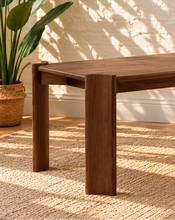 Load image into Gallery viewer, Darius rectangular dining table in natural brown Mindi wood veneer with wide panel legs and visible wood grain.
