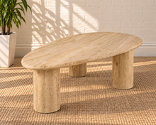 Load image into Gallery viewer, Eisley beige travertine freeform coffee table with three cylindrical pedestal legs and natural stone variation.
